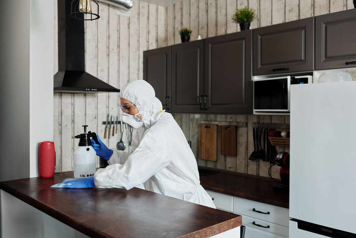 Cleaner sanitizing a bright commercial office workspace in Princeton, NJ
